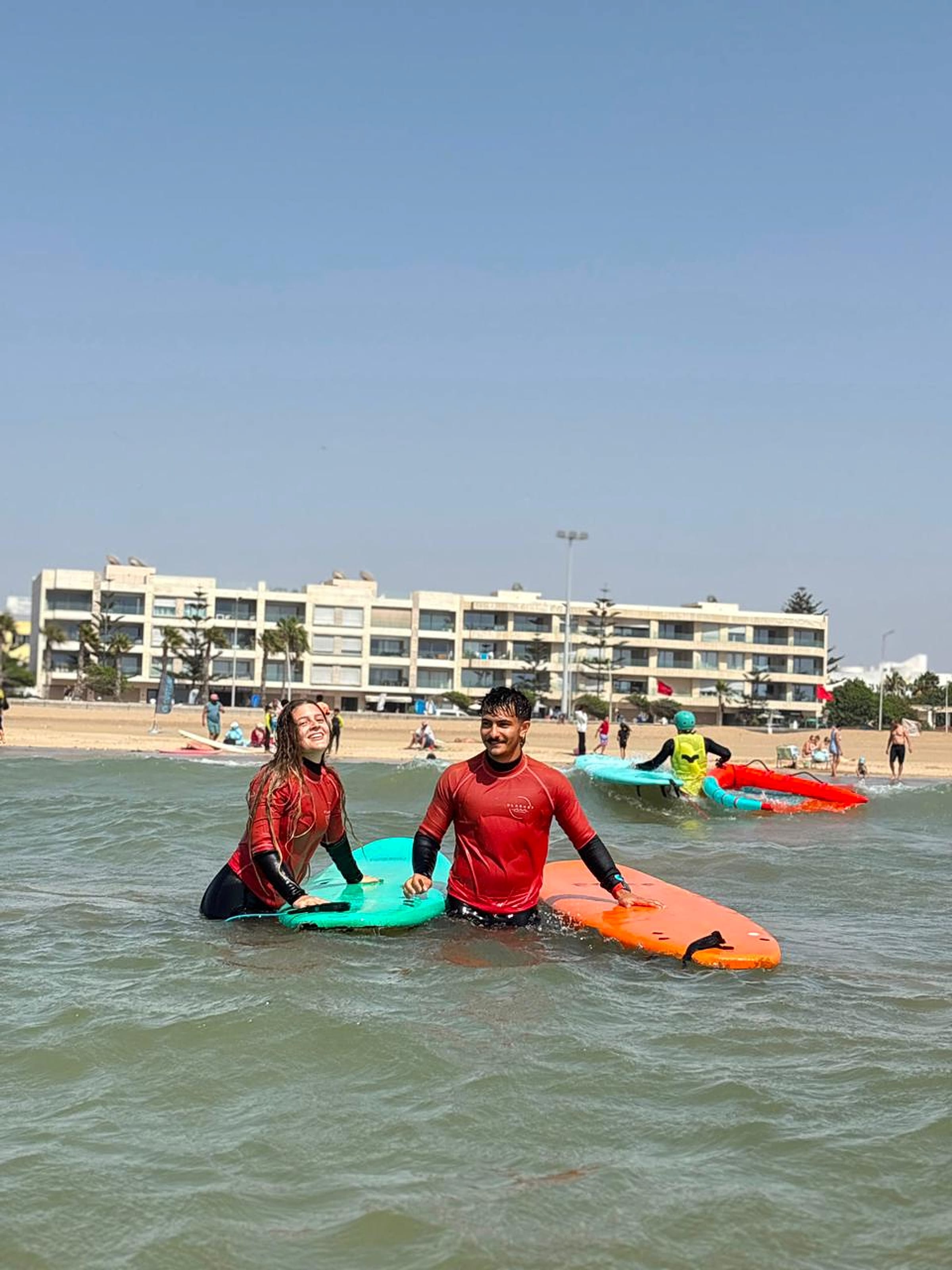 Surfers practise with their boards in shallow Atlantic water at Essaouira.