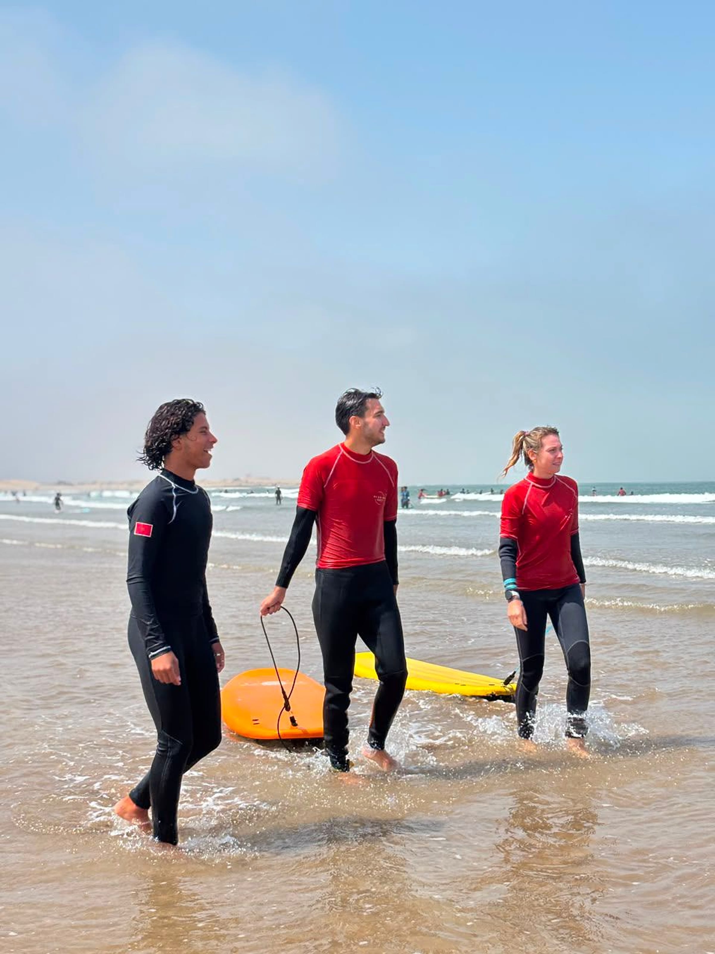Surfers carry their boards into the water from Essaouira beach.